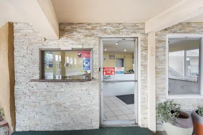 a door to a building with a brick wall at Americas Best Value Inn & Suites Anaheim in Anaheim