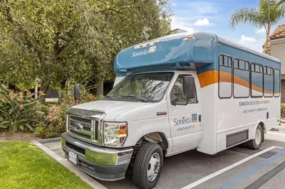 a shuttle bus parked in a parking lot at Sonesta ES Suites Chatsworth in Chatsworth