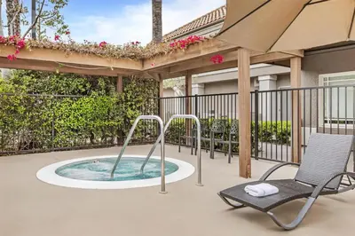 a hot tub and a chair on a patio at Sonesta ES Suites Chatsworth in Chatsworth