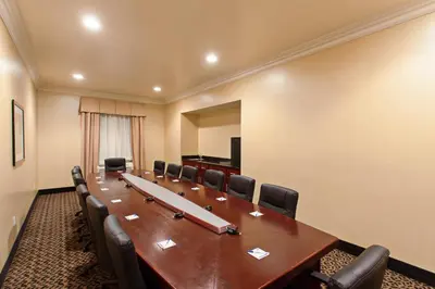 a conference room with a long wooden table and chairs at Holiday Inn Express Hotel & Suites Los Angeles Airport Hawthorne by IHG in Hawthorne