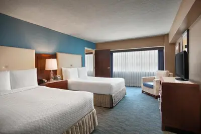 a hotel room with two beds and a flat screen tv at Crowne Plaza Hotel Los Angeles Harbor by IHG in San Pedro