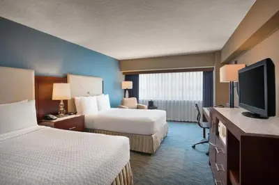 a hotel room with two beds and a flat screen tv at Crowne Plaza Hotel Los Angeles Harbor by IHG in San Pedro