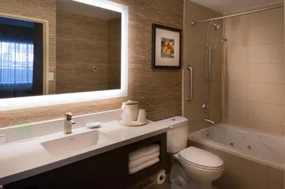 a bathroom with a sink and a toilet and a shower at Holiday Inn Express & Suites Pasadena - Los Angeles by IHG in Pasadena