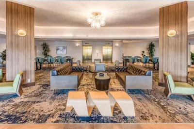 a large lobby with couches and tables and chairs at DoubleTree by Hilton Carson in Carson