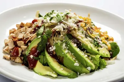 a white plate of food with a salad on it at DoubleTree by Hilton Carson in Carson