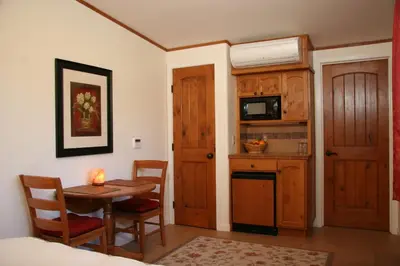 a room with a table and a kitchen with a small table at Ojai Retreat & Inn in Ojai