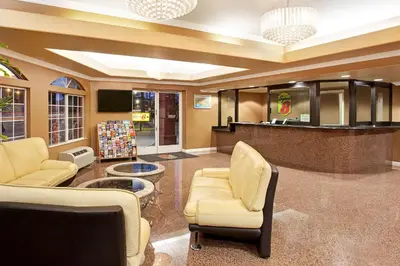 a lobby with chairs and a bar in a store at Super 8 by Wyndham Los Angeles Downtown in Los Angeles