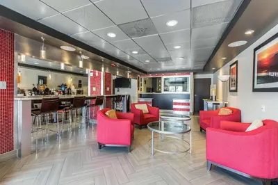 a restaurant with red chairs and a bar at Comfort Inn Los Angeles near Hollywood in Los Angeles