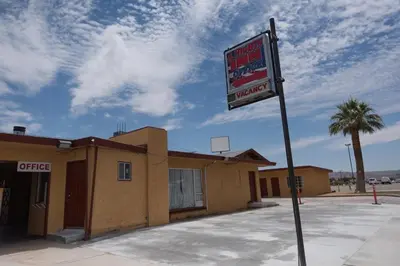 a motel sign in front of a building at A Nights Inn in Ridgecrest