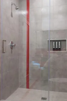 a shower with a glass door in a bathroom at Astro Pasadena Hotel in Pasadena
