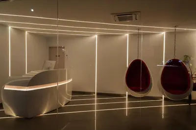 a room with two red chairs and a table at Astro Pasadena Hotel in Pasadena