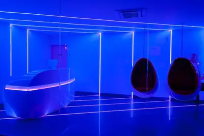 a blue room with two chairs and a table at Astro Pasadena Hotel in Pasadena