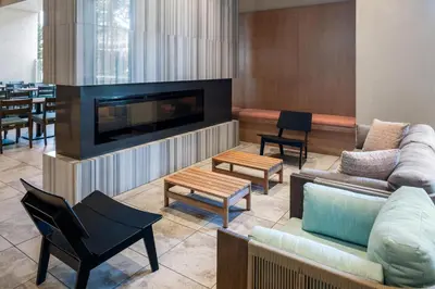 a living room with furniture and a large fireplace at Hyatt House at Anaheim Resort/Convention Center in Anaheim