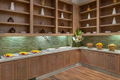 a kitchen with wooden cabinets and shelves at Hyatt House at Anaheim Resort/Convention Center in Anaheim