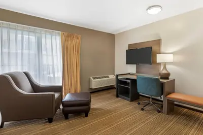 a room with a desk and a computer and a chair at Comfort Inn Cockatoo Near LAX Airport in Hawthorne