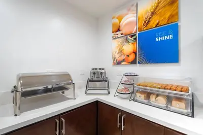 a kitchen with a counter with some food on it at Comfort Inn Cockatoo Near LAX Airport in Hawthorne