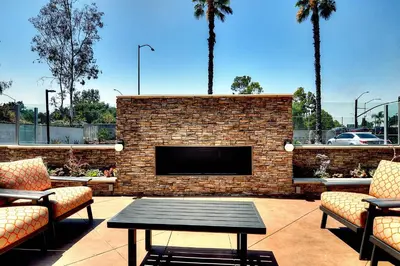 a brick fireplace with a television in a patio at Fairfield Inn & Suites by Marriott Los Angeles Rosemead in Rosemead