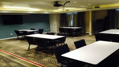 a conference room with white tables and chairs at Holiday Inn Express Bakersfield by IHG in Bakersfield