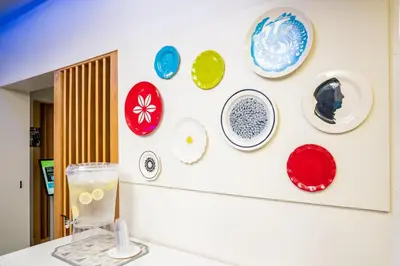 a wall with plates hanging on a wall at Holiday Inn Express Hotel & Suites Hesperia by IHG in Hesperia