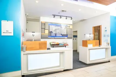 a room with white counters and a blue wall at Holiday Inn Express Hotel & Suites Hesperia by IHG in Hesperia