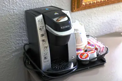 a coffee maker on a shelf on a wall at Baymont by Wyndham Barstow Historic Route 66 in Barstow