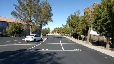 a white car parked in a parking lot at Baymont by Wyndham Barstow Historic Route 66 in Barstow