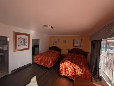 a hotel room with two beds and a window at Seaside Inn Motel in Port Hueneme