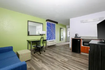 a living room with a blue couch and a table at Holiday Inn Express Lancaster by IHG in Lancaster