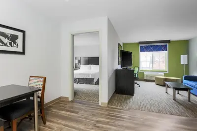 a hotel room with a bed and a living room at Holiday Inn Express Lancaster by IHG in Lancaster