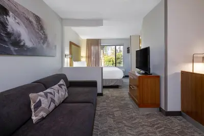 a hotel room with a couch and a bed at SpringHill Suites Pasadena Arcadia in Arcadia
