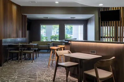 a restaurant with tables and chairs and a bar at SpringHill Suites Pasadena Arcadia in Arcadia