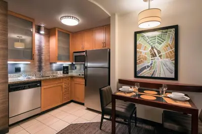a kitchen with a table and a stainless steel refrigerator at Residence Inn by Marriott Camarillo in Camarillo