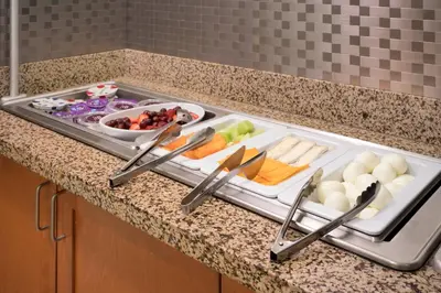 a tray of food on a counter with a tray of vegetables at Residence Inn by Marriott Camarillo in Camarillo