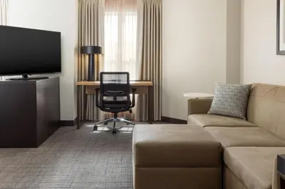 a living room with a couch and a desk at Residence Inn by Marriott Corona Riverside in Corona