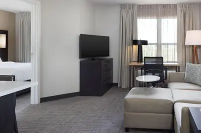 a hotel room with a couch and a tv at Residence Inn by Marriott Corona Riverside in Corona