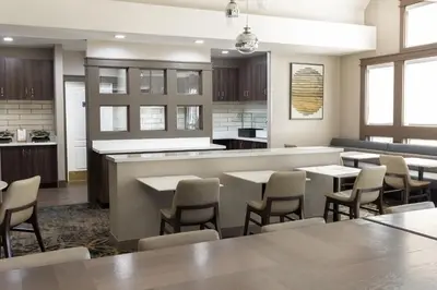 a restaurant with tables and chairs and a counter at Residence Inn by Marriott Corona Riverside in Corona