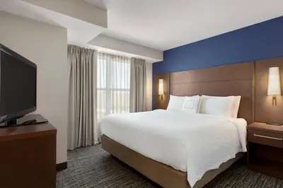 a hotel room with a large bed and a flat screen tv at Residence Inn by Marriott Palmdale Lancaster in Palmdale