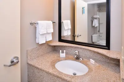 a bathroom with a sink and a mirror at SpringHill Suites by Marriott Corona Riverside in Corona