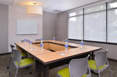 a conference room with a large wooden table and chairs at SpringHill Suites by Marriott Corona Riverside in Corona
