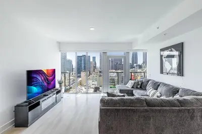 a living room with a couch and a tv at Top Floor 3 Bed 3 Bath Penthouse Living In Luxury in Los Angeles