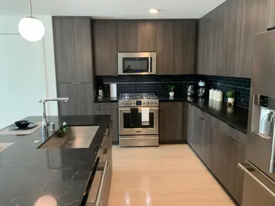 a kitchen with a stove and a microwave at Top Floor 3 Bed 3 Bath Penthouse Living In Luxury in Los Angeles