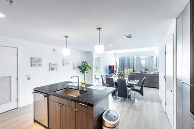 a kitchen with a sink and a table with chairs at Top Floor 3 Bed 3 Bath Penthouse Living In Luxury in Los Angeles