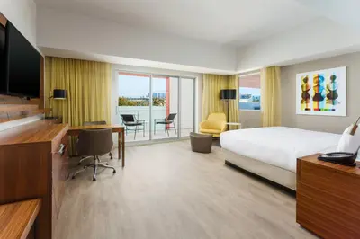 a hotel room with a bed and a desk and a television at Courtyard by Marriott Santa Monica in Los Angeles