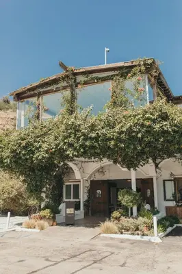 a building with a bunch of ivy growing on it at CALAMIGOS RANCH Resort & Spa in Malibu