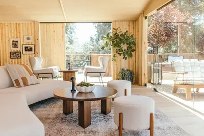 a living room with a couch and a table and chairs at CALAMIGOS RANCH Resort & Spa in Malibu
