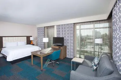 a hotel room with a bed and a desk and a couch at Hampton Inn & Suites LAX El Segundo in El Segundo