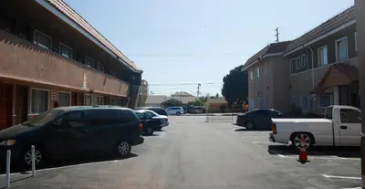 a group of cars parked in a parking lot at Encore Inn Inglewood in Inglewood