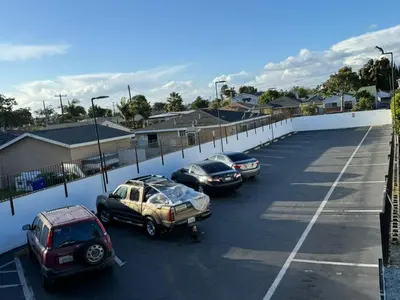 a group of cars parked in a parking lot at Encore Inn Inglewood in Inglewood