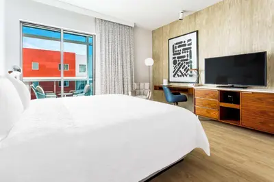 a hotel room with a large bed and a flat screen tv at Hampton Inn & Suites Santa Monica in Los Angeles