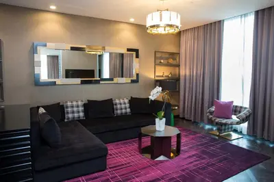 a living room with a couch and a mirror at Hotel Indigo Los Angeles Downtown by IHG in Los Angeles